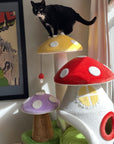 A cat standing on the mushroom platform of the Magic Mushroom Cat Tree