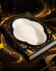 Book-shaped cat scratcher in golden celestial scene