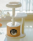 A cat inside the rattan-woven condo of the Milk Cloud Cat Tree