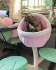 A cat on the Monster World Cat Tree in a green-themed gaming room
