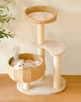white kitten lying in wicker nest of Sleeping in the Bowl Cat Tree on wooden floor