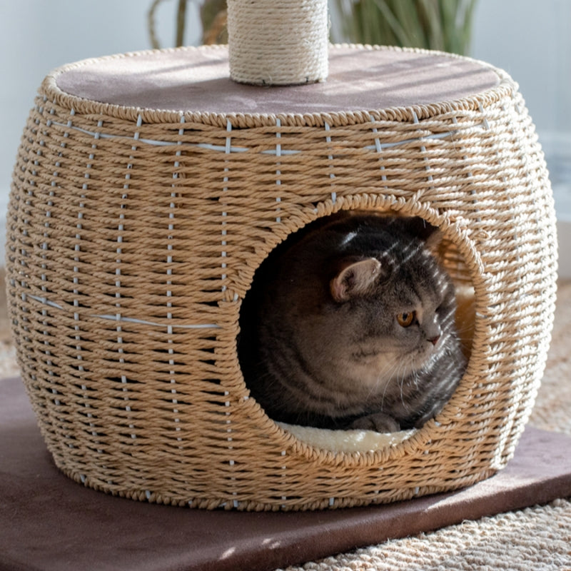 Detailed view of the woven hideaway on the Brown Rattan Cat Tree with a cat inside.