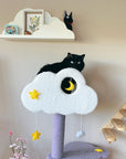 A black cat sitting on the top platform of the Moonlight Cat Tree