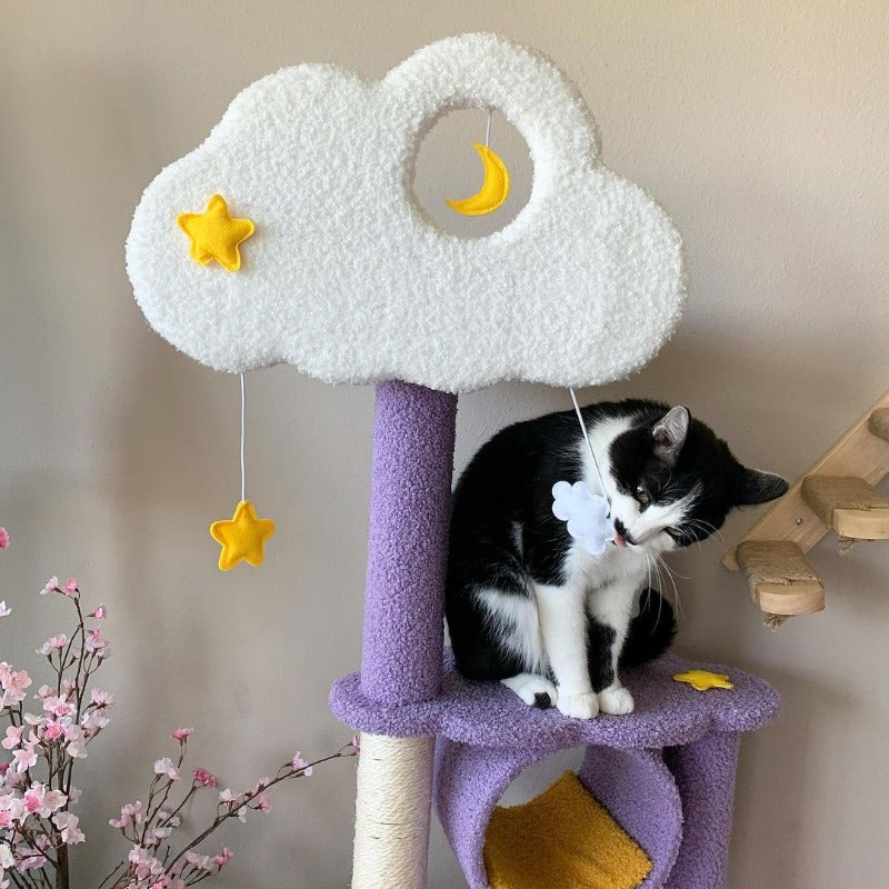 A cat playing with the hanging toy on the Moonlight Cat Tree