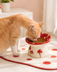 Cat eating from the elevated mushroom bowl