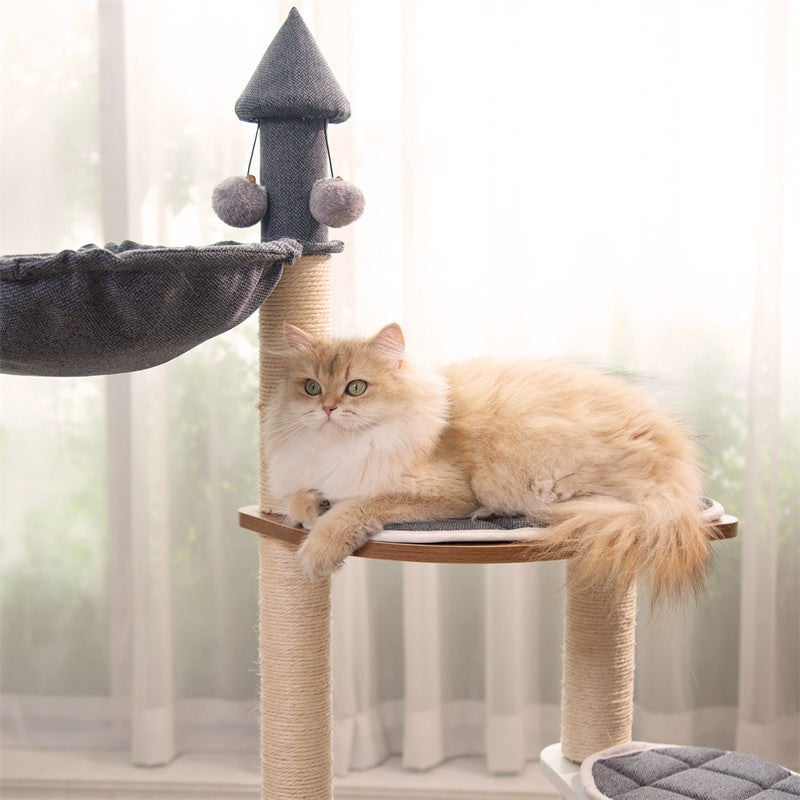 Cat sitting on Wooden House Cat Tree platform – comfortable and elevated spot for relaxation.