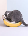 A playful cat engaging with the Banana Shaped Cat Scratching Pad.