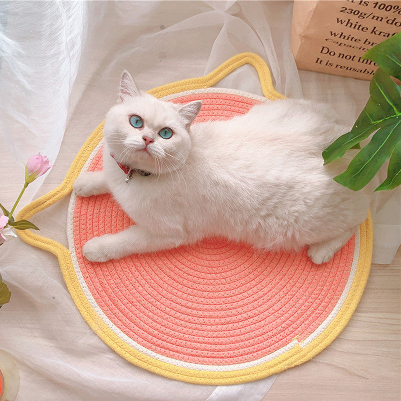 A cat sleeping comfortably on the Cat Ear Shaped Cat Scratching Pad.