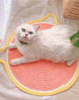 A cat sleeping comfortably on the Cat Ear Shaped Cat Scratching Pad.