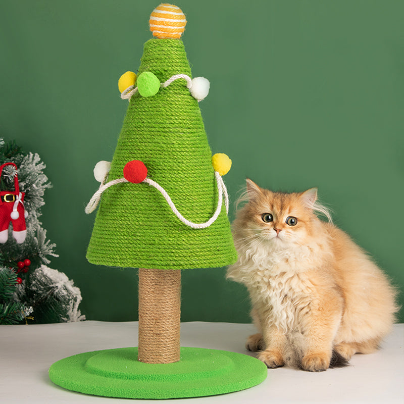 Cat sitting next to Christmas Tree Cat Scratcher, highlighting the festive design.