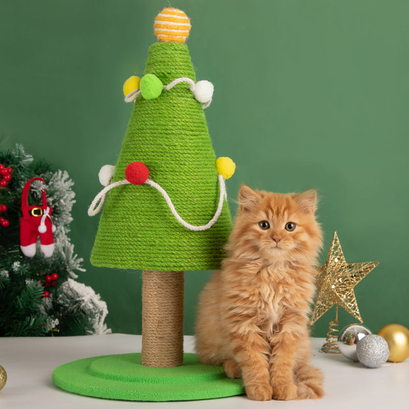 Kitten playing next to the Christmas Tree Cat Scratcher, emphasizing its suitability for all ages.